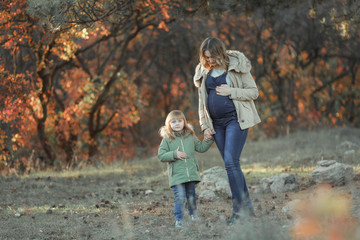 Mother and daughter walk together in the Park.