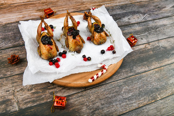 Cooking quail for christmas. On a wooden background. Wooden tray. Little turkey