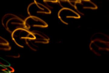 Fantasy christmas background. diffused swirling lights on a black background