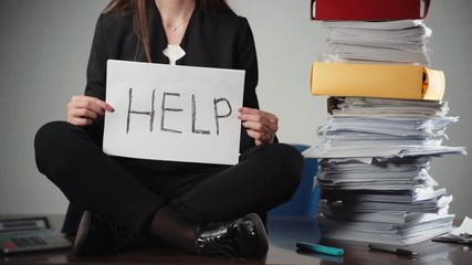 Close-up of office accountant sitting near the pile of documents and files and screaming for help. Tired woman holding sheet paper and approaching it to the camera. Begging for help, boring everyday
