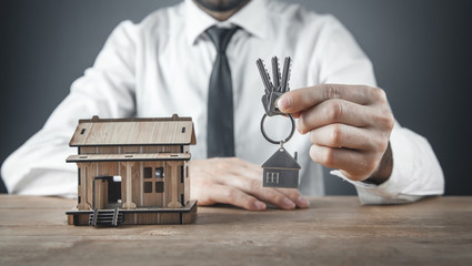 Real estate agent holding house keys.