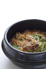 Pork and Korean spicy ramen noodles in traditional clay pot