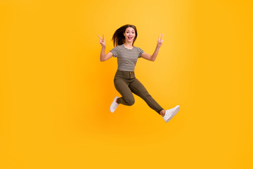Fototapeta na wymiar Full length photo of funky youth girl rest relax spring free time jump make v-sign wear stylish clothes isolated over bright color background