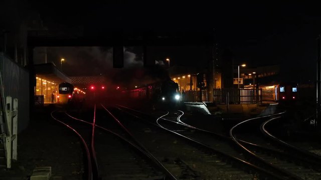 Railway station with crossing and steam engine.