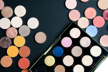 Make-up colorful eye shadow palettes isolated on black background. 