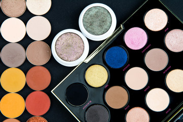 Make-up colorful eye shadow palettes isolated on black background. 