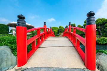Fototapeta na wymiar Red bridge in the park Japanese rock gardens as decoration for the garden accents lively culture represents Japan in nature
