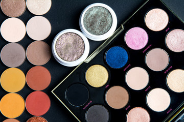 Make-up colorful eye shadow palettes isolated on black background. 