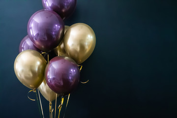 Set of gold and purple balls on a dark background. Holiday concept, postcard