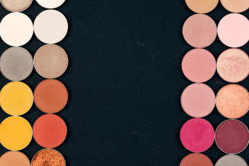 Make-up colorful eye shadow palettes isolated on black background.