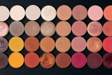 Make-up colorful eye shadow palettes isolated on black background.