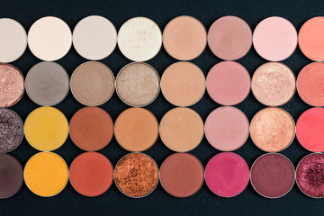 Make-up colorful eye shadow palettes isolated on black background.