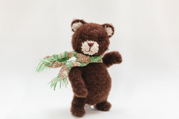 Teddy bear dancing on a white background in a scarf