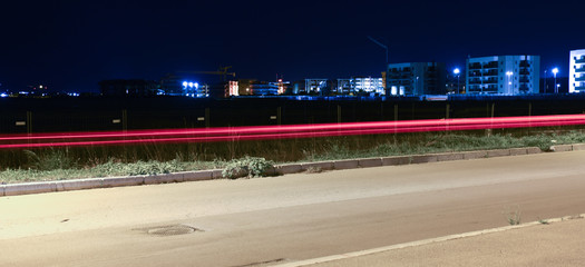 Light Car Trails in the City by Night on the Road, Long Exposure