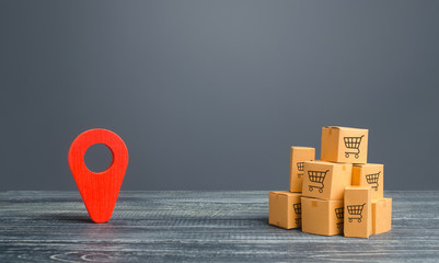 Red location pointer geolocation symbol and cardboard boxes. Distribution delivery of goods, freight transportation shipment. Logistics and warehousing. Global market and business, import and export.
