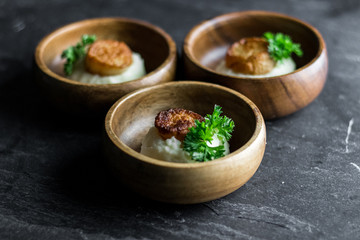 Scallops on Mashed Potatoes with Lime on Slate