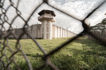 Prison with iron fences.Prison or jail is a building where people are forced to live if their freedom has been taken away.Prison is the building use for punishment prisoner. - obrazy, fototapety, plakaty