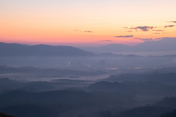 Obraz premium Mountain fog in morning sunrise landscape.beautiful view of mountain range in the mist background.Mountain valley texture in chiang rai northern province of thailand