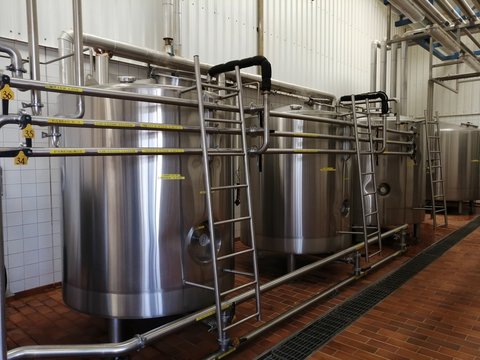 Tanks With Chemicals In The Disinfecting Facility Of The Dairy Farm