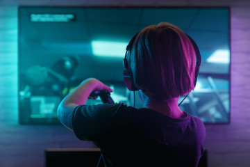 Little boy playing video game in the dark room © rangizzz
