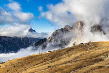 Dolomite peaks covered by clouds amazing view from Tre Cime di Lavaredo hiking trail
