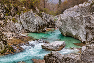 Fototapeta na wymiar Rocky canyon and clear emerald waters of Soca river in Slovenia