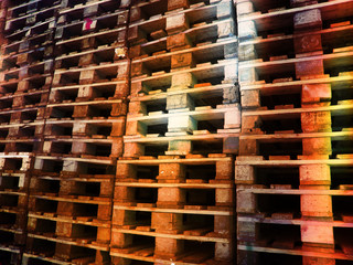 wooden pallets in different colors stacked            