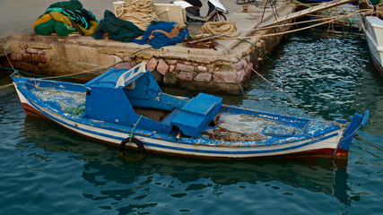 old blue fishing boat moored in harbor