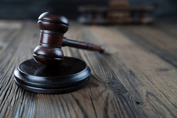 Law concept. Judge’s gavel and scale on dark background.