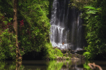 Fototapeta na wymiar Woman near Labuhan Kebo Waterfall located in Munduk, Bali