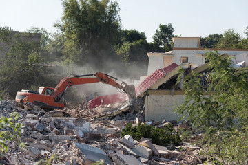 Collapse moment of demolition concrete house on construction site