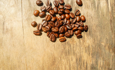 large grains of coffee on a wooden table.