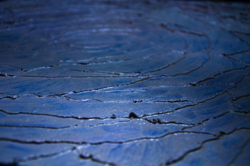Modern art abstract pattern of curved lines oil paints on dark blue background