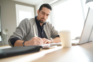 Man using laptop computer in co-working office
