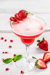 Strawberry and tequila berry cocktail shot closeup vertical