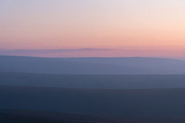 Fototapeta na wymiar the orange skies of a misty Exmoor catching the last glow just after sunset