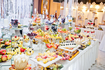 Dessert table of delicious fruits on wedding reception.