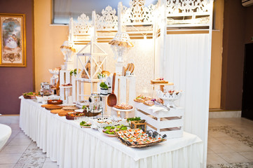 Dessert table of delicious snacks on wedding reception.