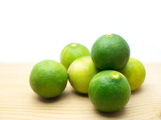 Lime isolated on a wooden floor.