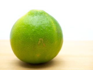 Lime isolated on a wooden floor.