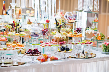 Dessert table of delicious fruits on wedding reception.