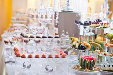 Dessert table of delicious sweets on wedding reception.