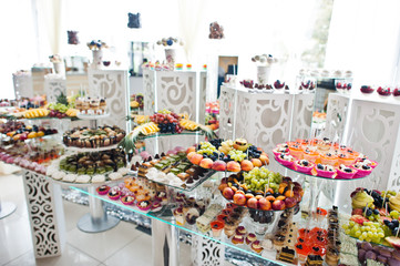 Dessert table of delicious sweets on wedding reception.