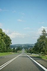 Fototapeta premium Road traffic on asphalt road in Poland in sunny day.