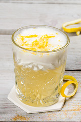 Cocktail with egg and lemon in a glass cup