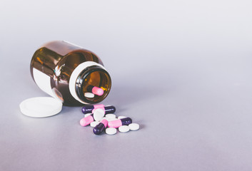 pills and bottle on grey background