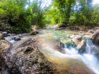 A hot spring merging with cold river creating a perfect temperature of water for a swim in Bajawa,...