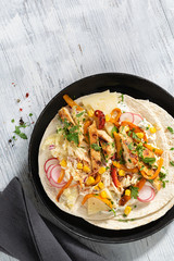 Coleslaw Chicken Wraps or tacos with mixed vegetables on a light background, copy space. Top view, hard light. Delicious snack.