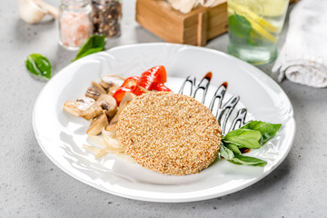 Turkey cutlet on a white plate in the decor