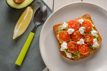 Delicious toast with avocado, tomato and ricotta